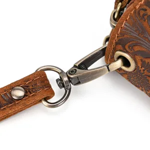 Vintage embossed genuine leather wallet hardware detail close-up showing clasp and strap.