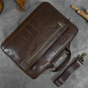 Dark brown leather briefcase for men with laptop compartment, top handle and shoulder strap.