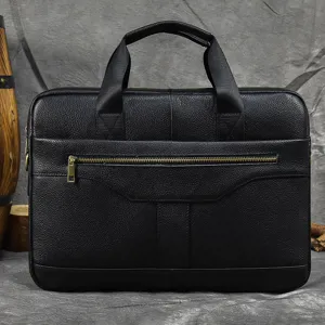 Black leather business briefcase close-up, showing detailed texture, metal zipper and handles.