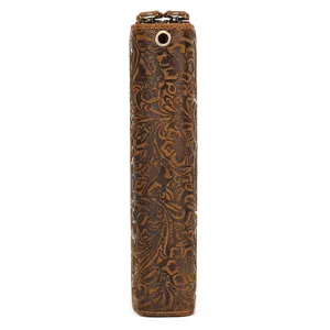 Vintage embossed leather long wallet detail view with double zippers and classic floral pattern.