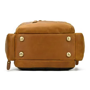 Men's leather backpack bottom detail view, showing durable crazy horse leather and metal feet.