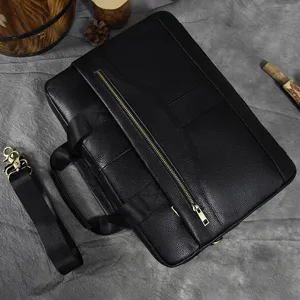 Detailed view of black genuine top layer cowhide business laptop briefcase with metal zipper.