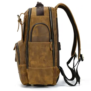 Side detail view of brown crazy horse leather vintage backpack with multiple zipper pockets.