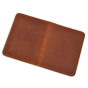 Detailed close-up of brown crazy horse genuine leather minimalist bi-fold card holder.