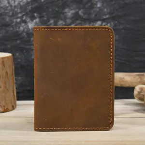 Genuine leather minimalist card holder detail view, retro bifold design with visible stitching.