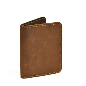 Vintage brown leather wallet close-up showing fine texture and durable stitching.