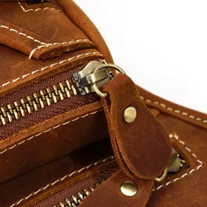 Vintage genuine leather waist bag detail, premium cowhide texture with durable metal zippers.