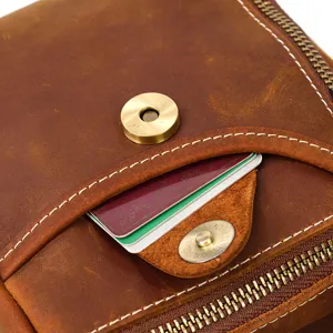 Close-up detail of retro genuine leather waist bag, showing fine stitching and snap button.