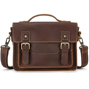 Vintage brown leather messenger bag with top handle and double buckle straps for daily use.