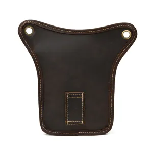 Detailed close-up of genuine leather drop leg bag panel, showing fine contrast stitching.
