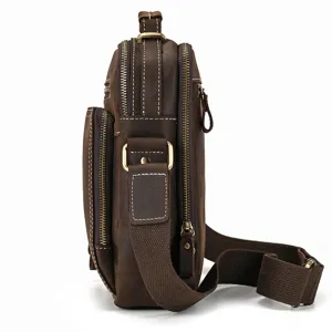 Vintage genuine leather crossbody bag detail side view with multiple zipper compartments.