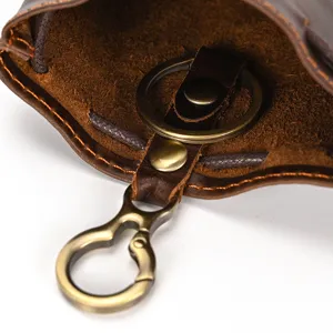 Close-up detail of genuine leather coin purse interior, featuring bronze keyring and hardware.