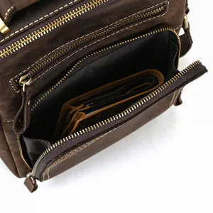 Vintage genuine leather shoulder bag detail shot, multi-pocket design for men and women.