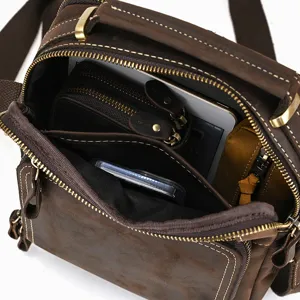 Vintage brown genuine leather shoulder bag detail showing multi-compartment interior capacity.
