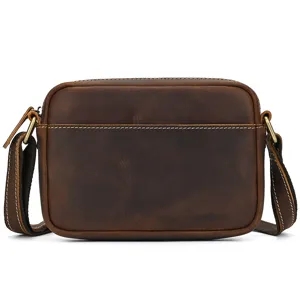 Close-up detail of retro men's brown crazy horse leather shoulder crossbody bag texture