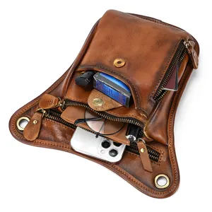 Men's vintage genuine leather drop leg bag, detail view showing multi-pocket capacity.