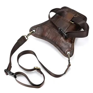 Detail shot of vintage brown genuine leather tactical leg bag, showing fine leather and straps.