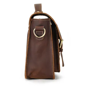Side detail view of a vintage brown crazy horse leather men messenger bag with metal ring.