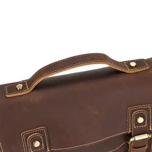 Detailed view of vintage crazy horse leather men's bag handle and buckle craftsmanship.