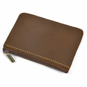 Close-up detail of retro genuine leather coin purse with zipper and contrast stitching.