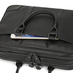 Black leather briefcase for men business laptop bag with dual zippers and front pocket.