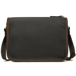 Detailed view of the dark brown genuine leather messenger bag highlighting fine stitching.