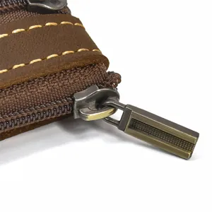 Leather wallet zipper detail, vintage crazy horse cowhide with contrast stitching.