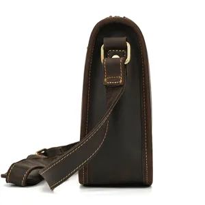 Detailed side view of vintage crazy horse leather messenger bag with sturdy metallic hardware.