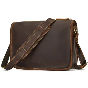 Close-up detail of retro crazy horse leather messenger bag strap stitching and metal hardware.