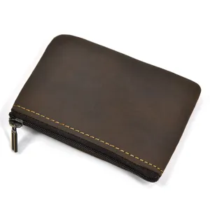 Close-up detail of vintage genuine crazy horse leather coin purse with neat yellow stitching.