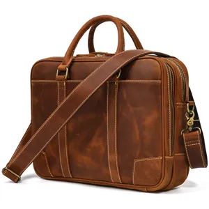 Men's brown leather briefcase, professional business laptop shoulder bag side detail.