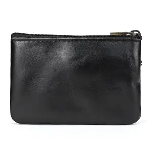 Minimalist black genuine leather coin purse with zipper closure. Portable retro cowhide wallet.