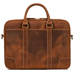 Detailed view of brown leather business briefcase with dual handles and metal hardware.
