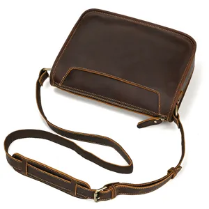 Vintage brown leather messenger bag for men, stylish retro shoulder crossbody bag detail view.
