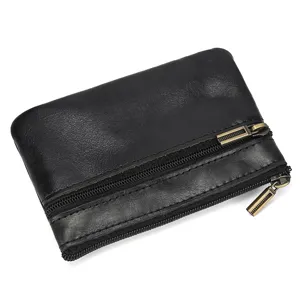 Close-up of black genuine leather double zipper coin purse with smooth metal hardware detail.