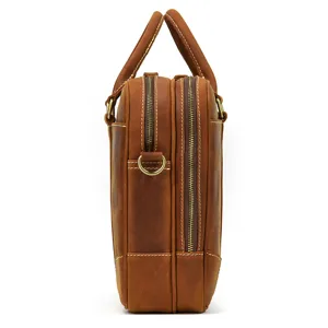 Leather briefcase side view showing multi-compartment design, durable brown cowhide material.