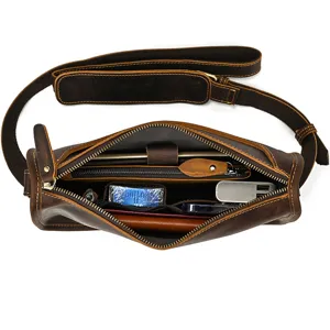 Vintage leather messenger bag interior detail showcasing multi compartments and storage design.
