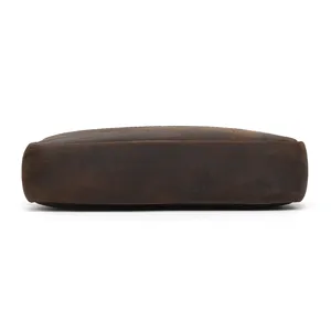 Detailed bottom view of vintage brown genuine leather men bag, showing durable smooth texture.