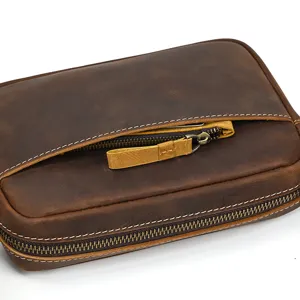 Close-up detail of retro brown crazy horse leather bag pocket with neat white stitching.