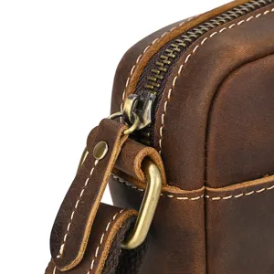 Detailed view of vintage men's leather shoulder bag showing zipper and hardware craftsmanship.
