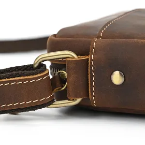 Close up detail of vintage brown crazy horse leather messenger bag shoulder strap buckle hardware.
