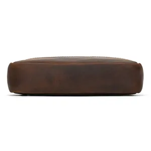 Close-up detail shot of the brown crazy horse leather bag bottom showing fine stitching texture.