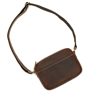 Detail view of retro men's mad horse leather crossbody shoulder bag with metal hardware.