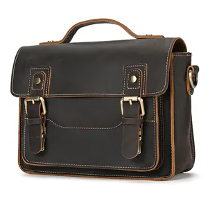 Vintage leather messenger bag detail showing craftsmanship, metal buckles and durable stitching.