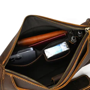 Close-up view showing the spacious multi-compartment interior of vintage leather bag.
