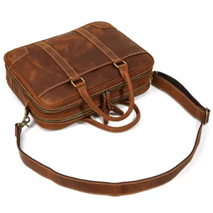 Brown leather business briefcase detail showing dual zipper and adjustable shoulder strap.