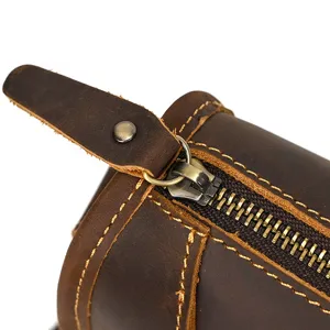 Detail shot of vintage brown crazy horse leather men shoulder bag zipper texture.