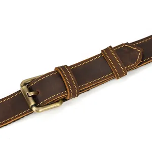 Vintage crazy horse leather bag strap detail, premium metal buckle and neat stitching.
