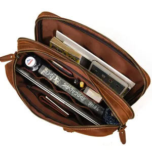 Interior detail of brown leather men's business briefcase showing multi-pocket storage capacity.