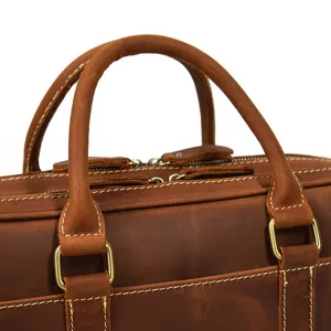 Detail view of brown leather briefcase, showing premium cowhide texture and durable hardware.